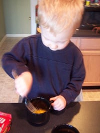 The toddler beating the eggs