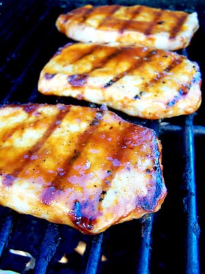 Sweet & Spicy Grilled Pork Chops on grill