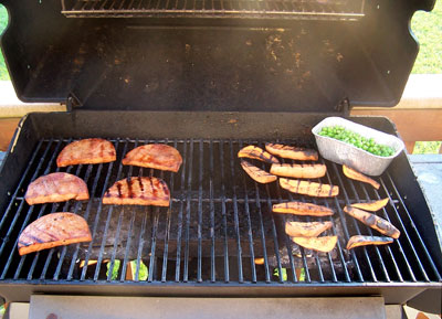 Grilled Ham Steaks with Sweet Potatoes on grill