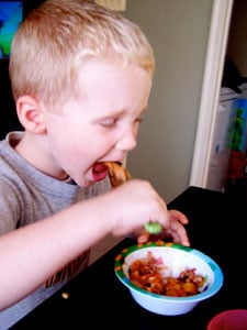 Toddler eating turk-a-roni