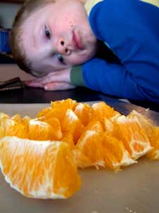 toddler with oranges