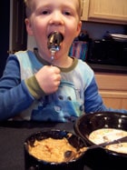 toddler eating Homemade Apple Pie Oatmeal 3
