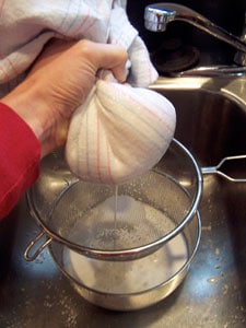 squeezing almond milk