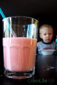 Glass of smoothie by child