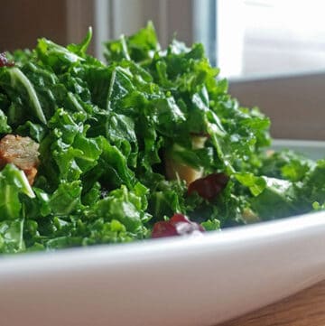 Kale Salad with Leftover Pork, Dried Cranberries and Sage Maple Dressing on plate
