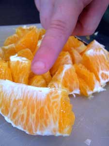 toddler finger with oranges