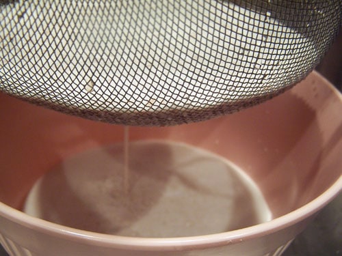 close up of almond milk draining
