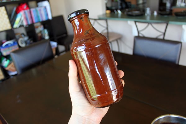Holding jar of Homemade BBQ sauce